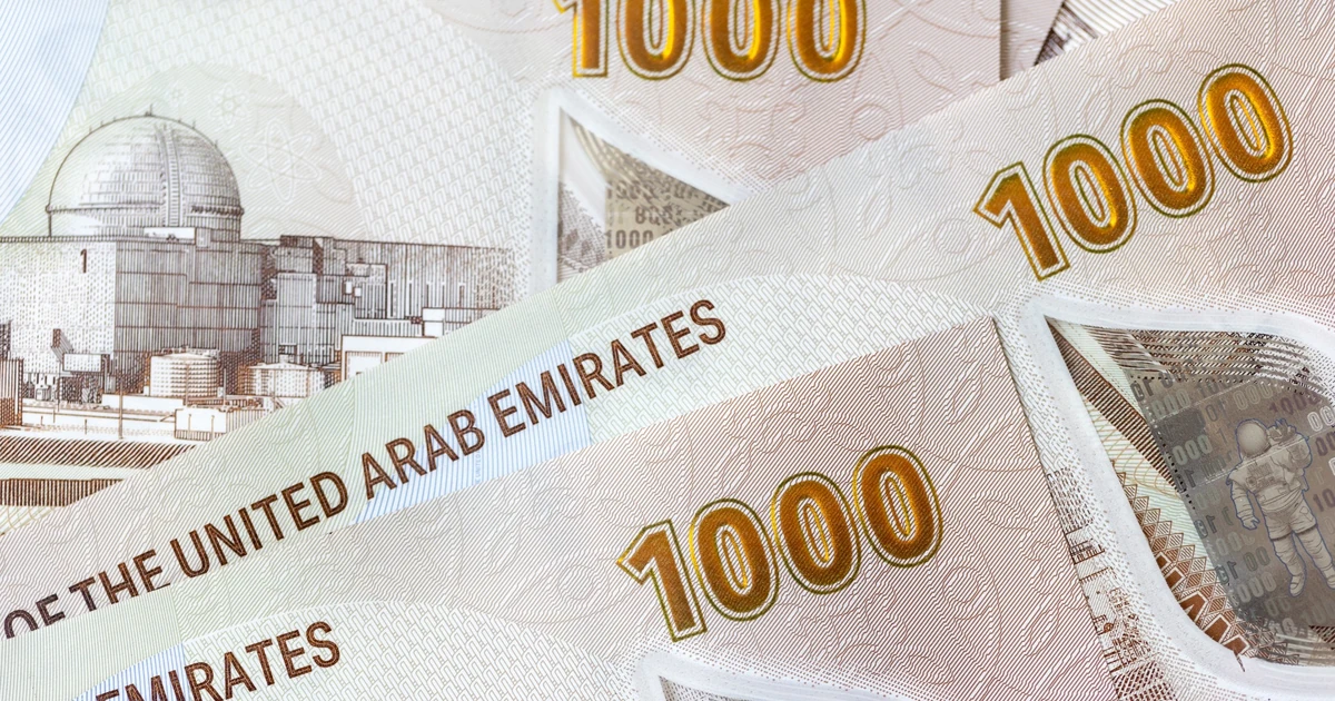 UK visa fee shown in AED alongside a passport and payment card for a UAE resident applicant